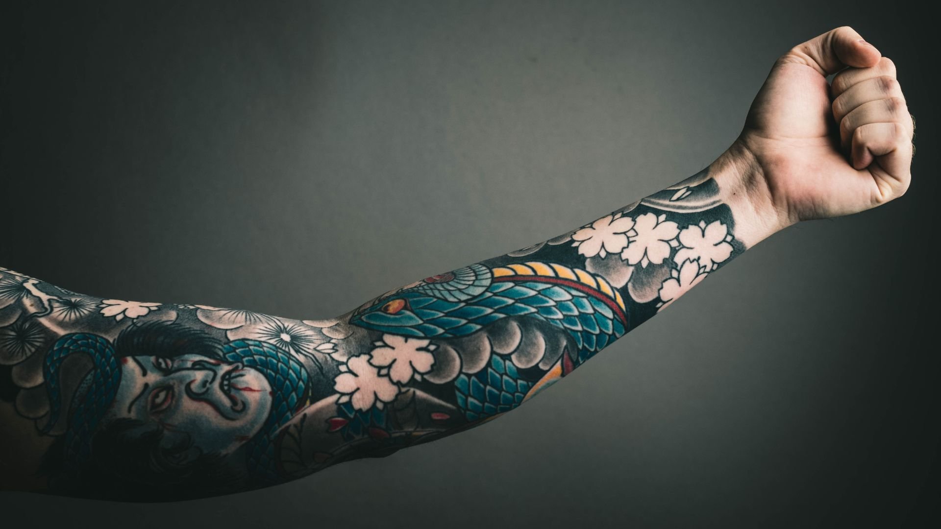 Detailed Japanese-style tattoo sleeve with koi fish and cherry blossoms